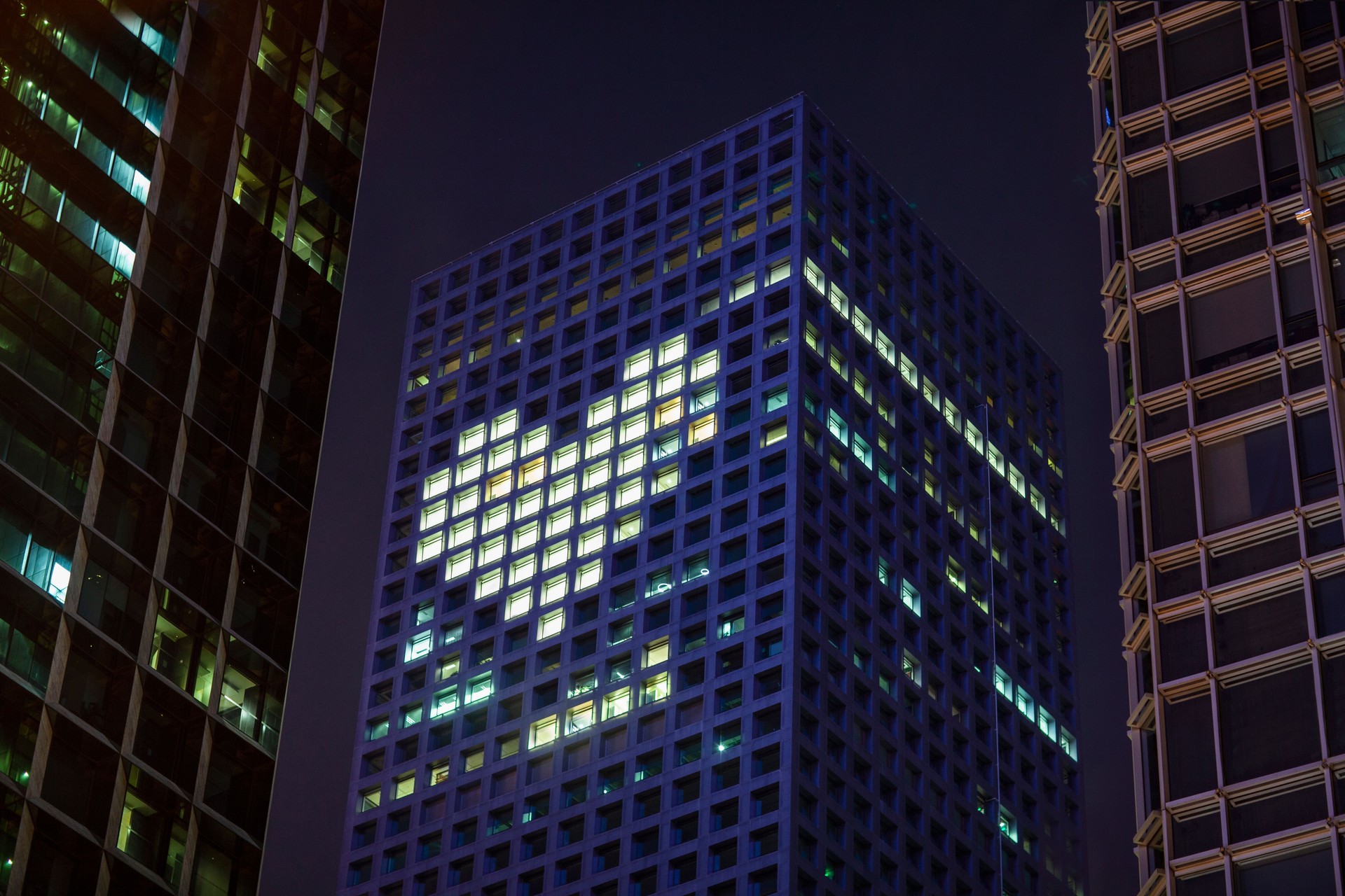 Heart shape in lights in downtown district office business buildings at night